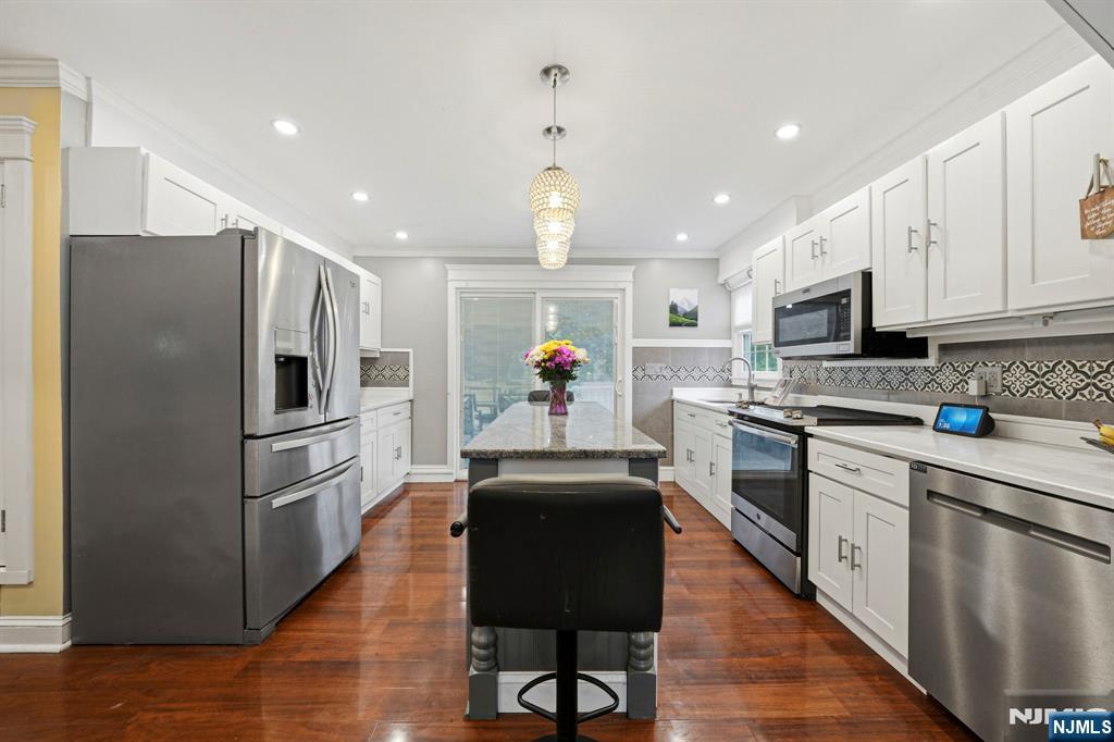 52 Barbara Drive Pompton Lakes, NJ 07442 - Photo 9 of 30 a kitchen with stainless steel appliances granite countertop a refrigerator a stove top oven a sink dishwasher and a refrigerator