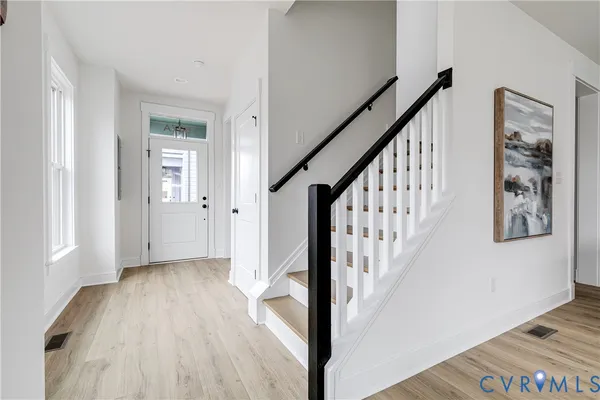 a view of an entryway with wooden floor