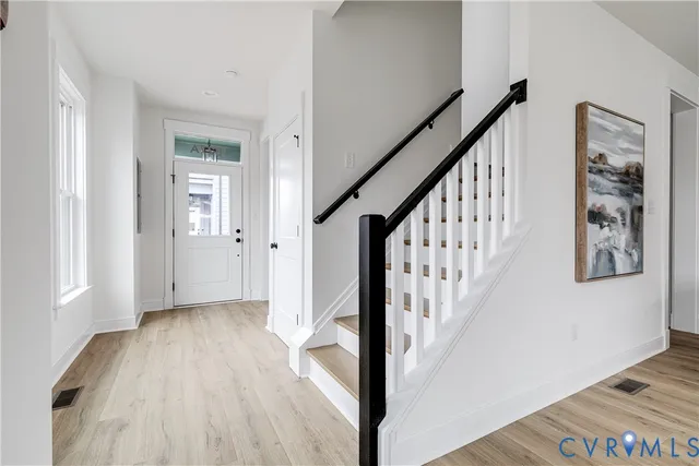 a view of an entryway with wooden floor