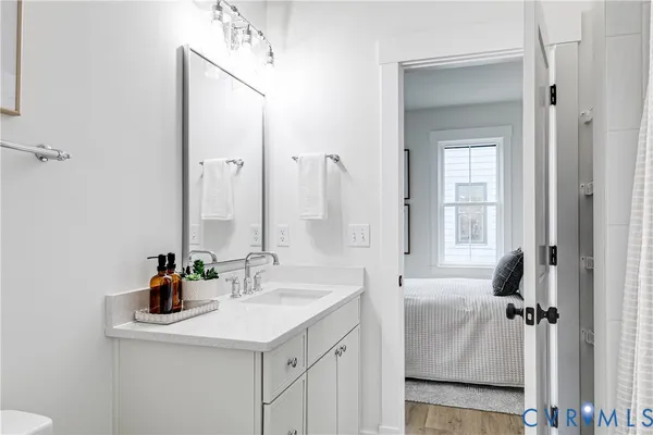 a bathroom with a sink tub double vanity and a mirror
