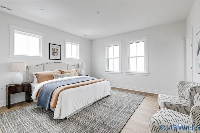 a bedroom with bed and a couch