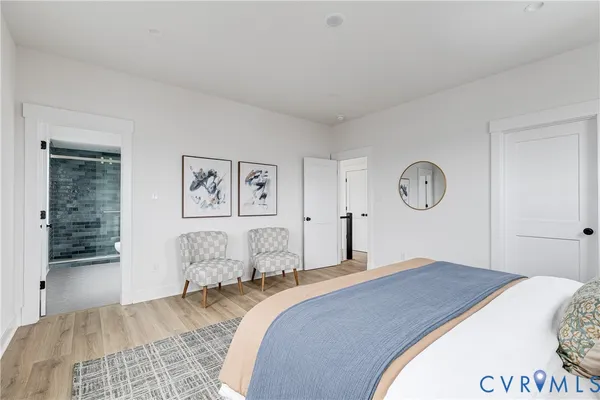 a bedroom with a large bed and a painting on the wall
