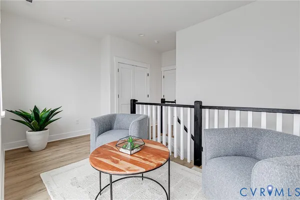 a living room with furniture and wooden floor