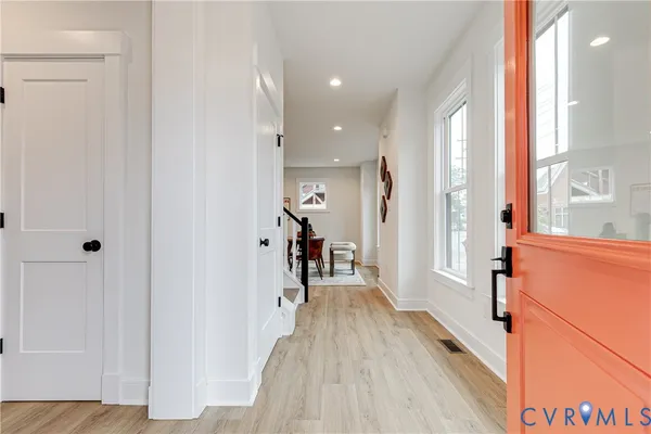 a view of a hallway with a wooden floor