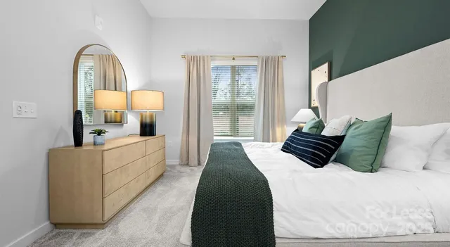 a bed room with a bed mirror and a lamp