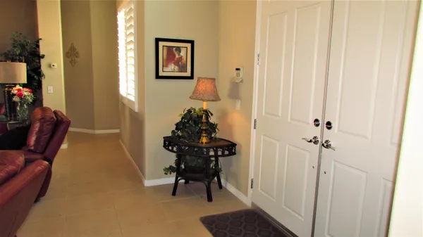 a view of a hallway with furniture and a potted plant