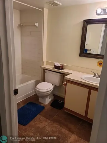 a bathroom with a toilet and a shower curtain