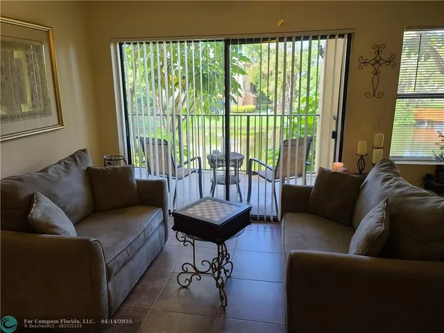 a view of a chairs and table in patio from a window