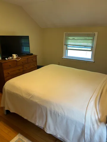 a bed sitting in a bedroom next to a window