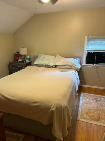 a bed sitting in a bedroom next to a window