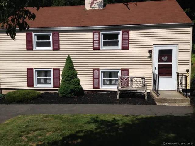 a view of house with backyard and garden