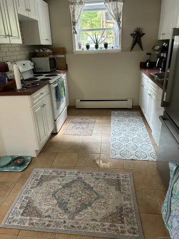 a kitchen with a stove a sink and a counter space