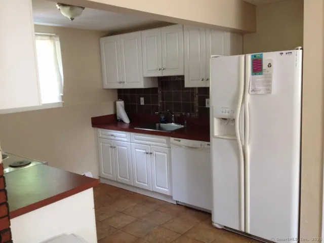 a kitchen with a refrigerator and a sink