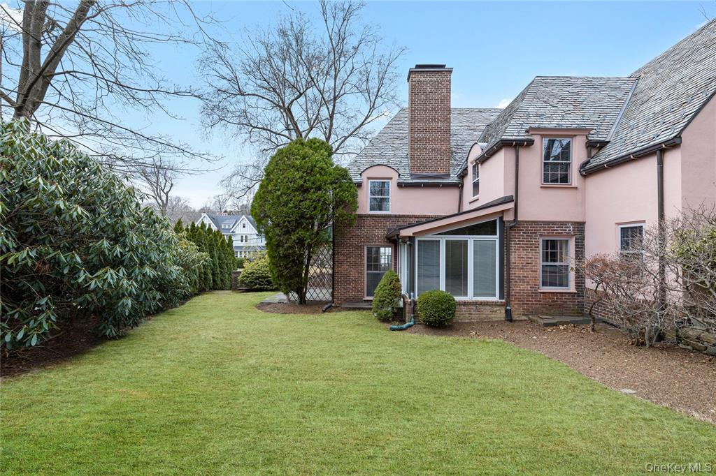 6 Fox Meadow Road Scarsdale, NY 10583 - Photo 16 of 20 Back of property featuring a lawn, a chimney, brick siding, and stucco siding