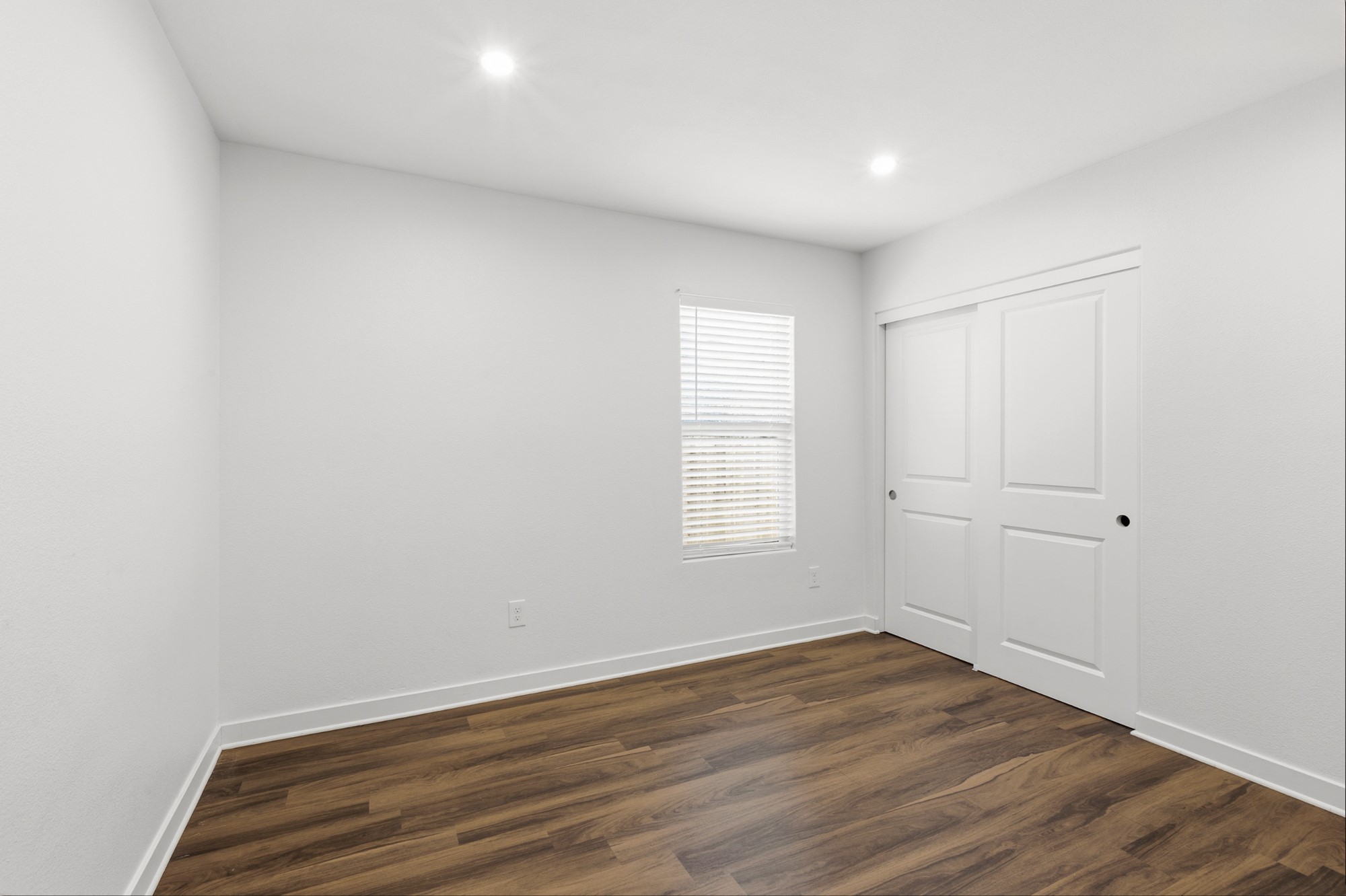 108 Irene Street Elgin, TX 78621 - Photo 19 of 29 Unfurnished bedroom featuring dark wood-style floors, recessed lighting, and a closet