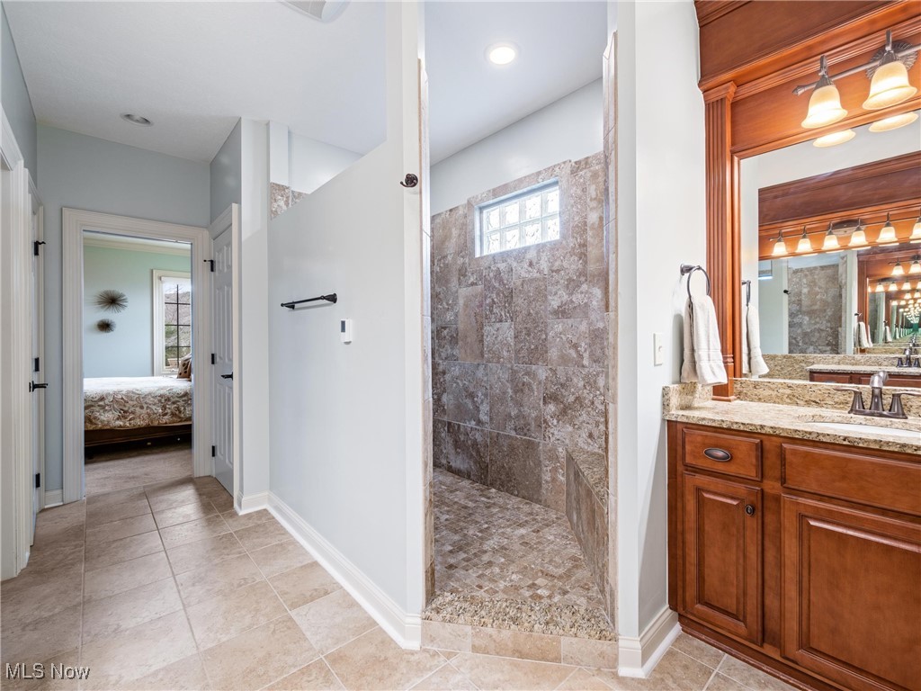 5349 Slater Ridge Westerville, OH 43082 - Photo 29 of 50 Bathroom featuring vanity, walk in shower, connected bathroom, and light tile patterned floors