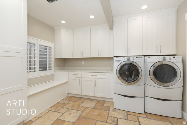 704 West Vahe Street Draper, UT 84020 - Photo 20 of 35 Laundry room featuring extensive white cabinetry, light-toned countertop space, a built-in window bench, plantation shutters, and large format tile flooring