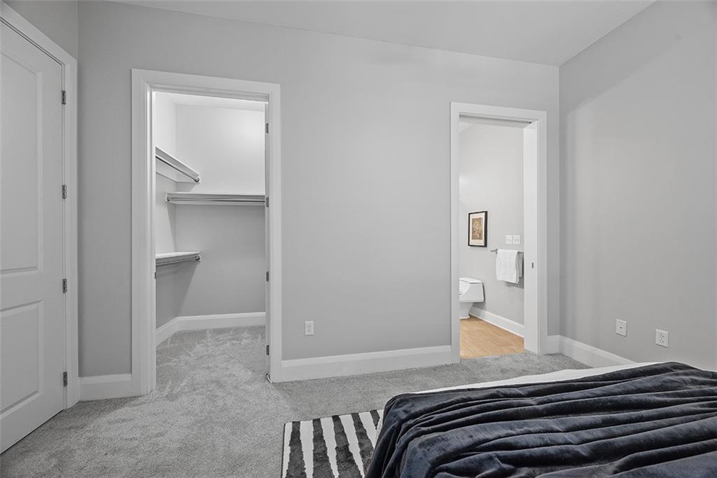 301 Fifth Avenue, Unit 506 Pittsburgh, PA 15222 - Photo 11 of 21 a bedroom with a bed and a mirror