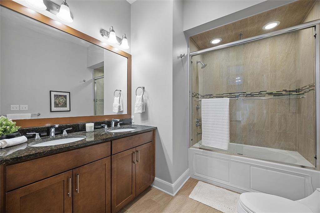 301 Fifth Avenue, Unit 506 Pittsburgh, PA 15222 - Photo 12 of 21 a bathroom with a granite countertop sink toilet and shower