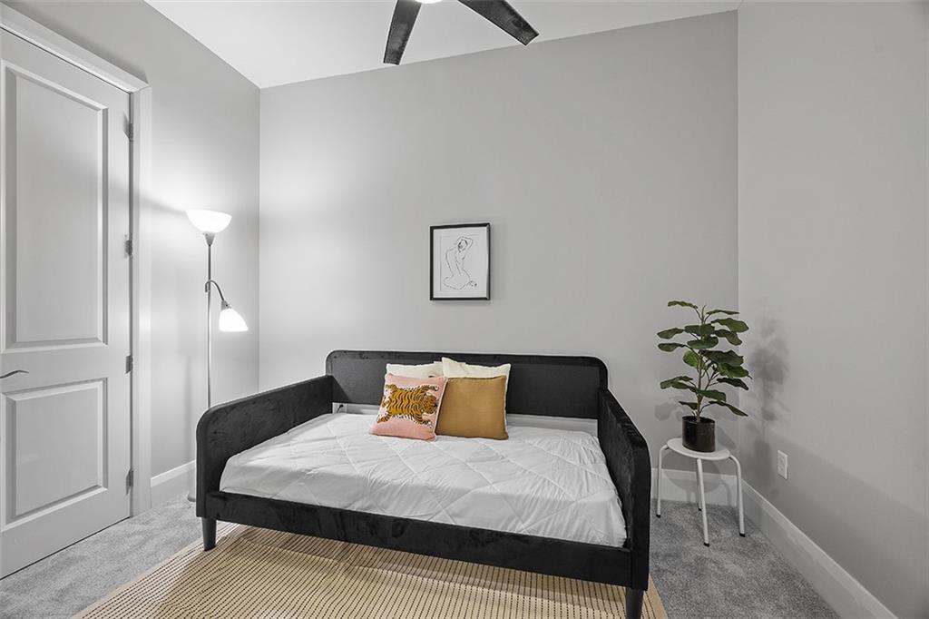 301 Fifth Avenue, Unit 506 Pittsburgh, PA 15222 - Photo 13 of 21 a bedroom with a bed and a potted plant