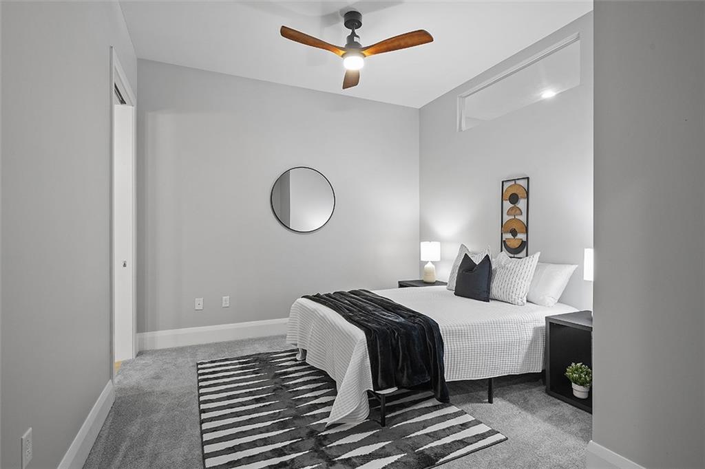 301 Fifth Avenue, Unit 506 Pittsburgh, PA 15222 - Photo 10 of 21 a bedroom with a bed and a chandelier