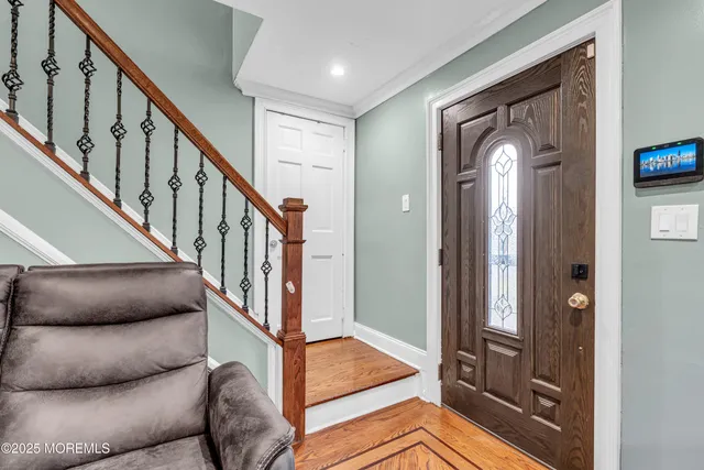 a living room with furniture and entryway