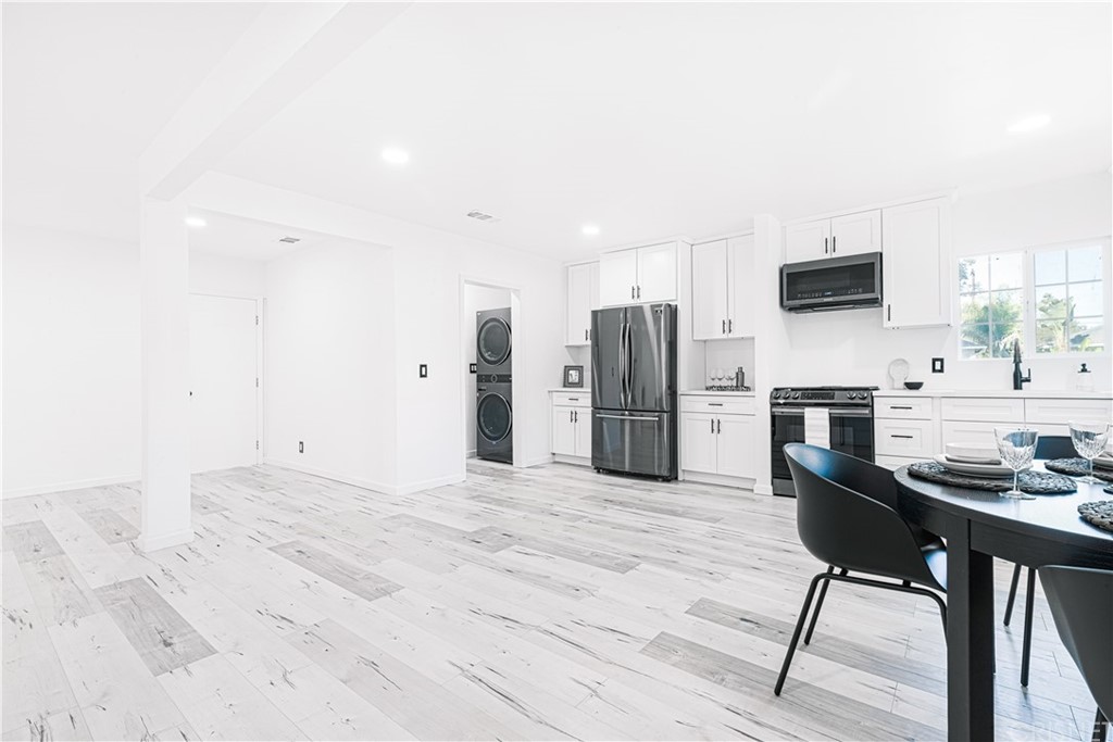 6725 Belmar Avenue Reseda, CA 91335 - Photo 14 of 32 a kitchen with stainless steel appliances kitchen island granite countertop a refrigerator stove top oven and sink