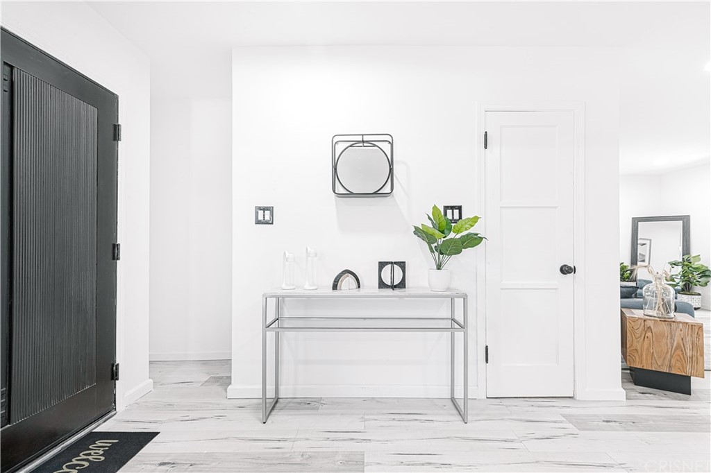 6725 Belmar Avenue Reseda, CA 91335 - Photo 16 of 32 a white bathroom with a sink and mirror