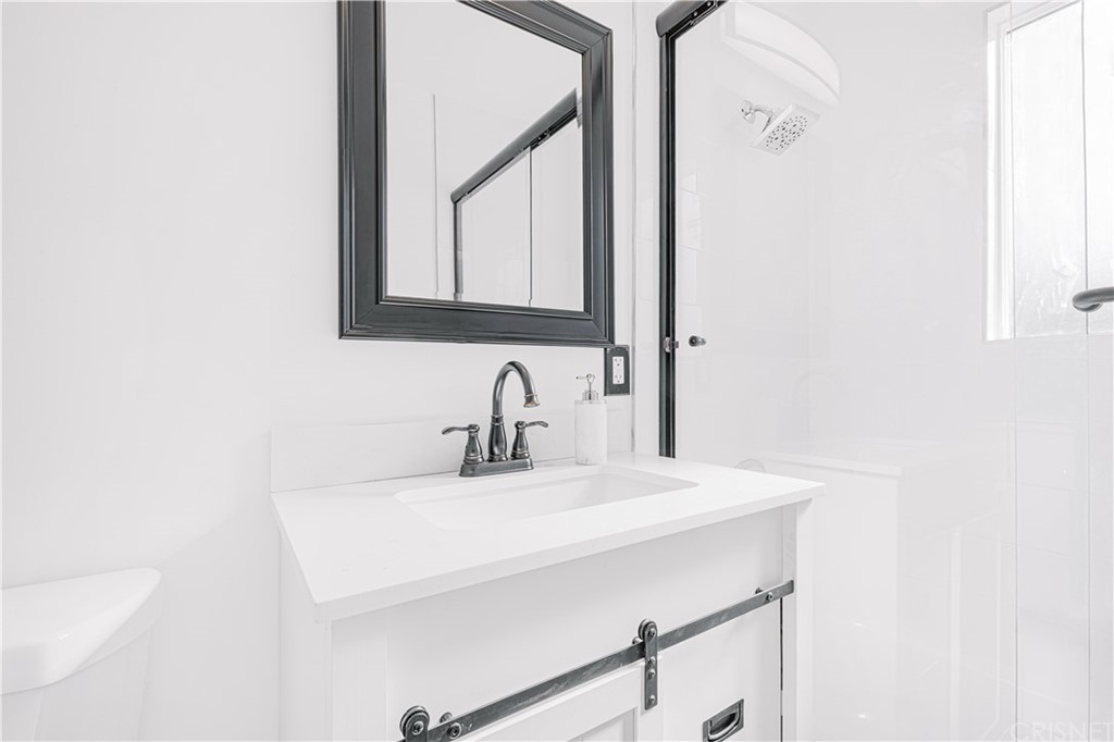 6725 Belmar Avenue Reseda, CA 91335 - Photo 32 of 32 a bathroom with a sink and a mirror