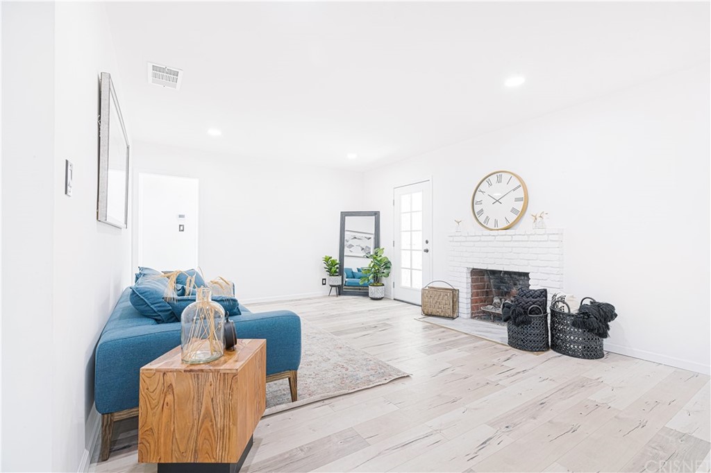6725 Belmar Avenue Reseda, CA 91335 - Photo 7 of 32 a living room with furniture a fireplace and a potted plant