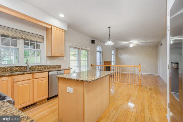 a view of a kitchen with granite countertop a sink and a stove