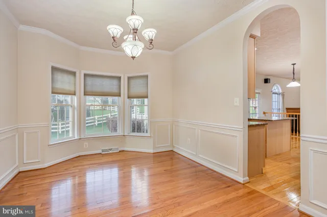 a view of a room with wooden floor and a large window