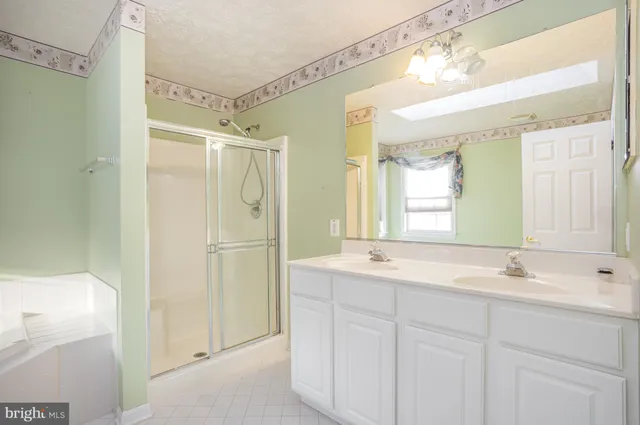 a bathroom with a shower sink and mirror