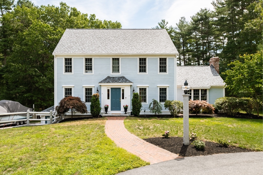 17 Gardner Road Duxbury, MA 02332 - Photo 1 of 42 a front view of a house with a yard table and chairs
