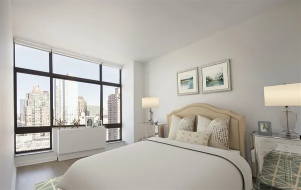 a bedroom with a large bed and a large window