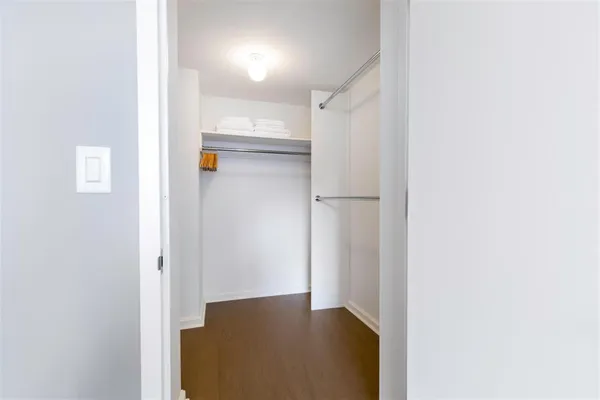 a view of walk in closet with empty racks