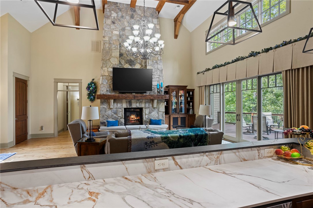 117 Sunrise Ridge Sunset, SC 29685 - Photo 7 of 44 A spacious living area boasts a grand stone fireplace and immediate deck access.