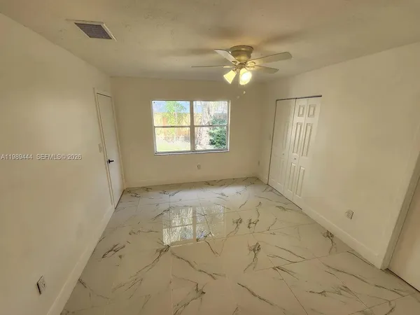a view of an empty room with a window
