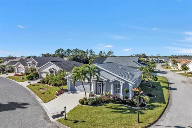 an aerial view of residential houses with outdoor space and swimming pool