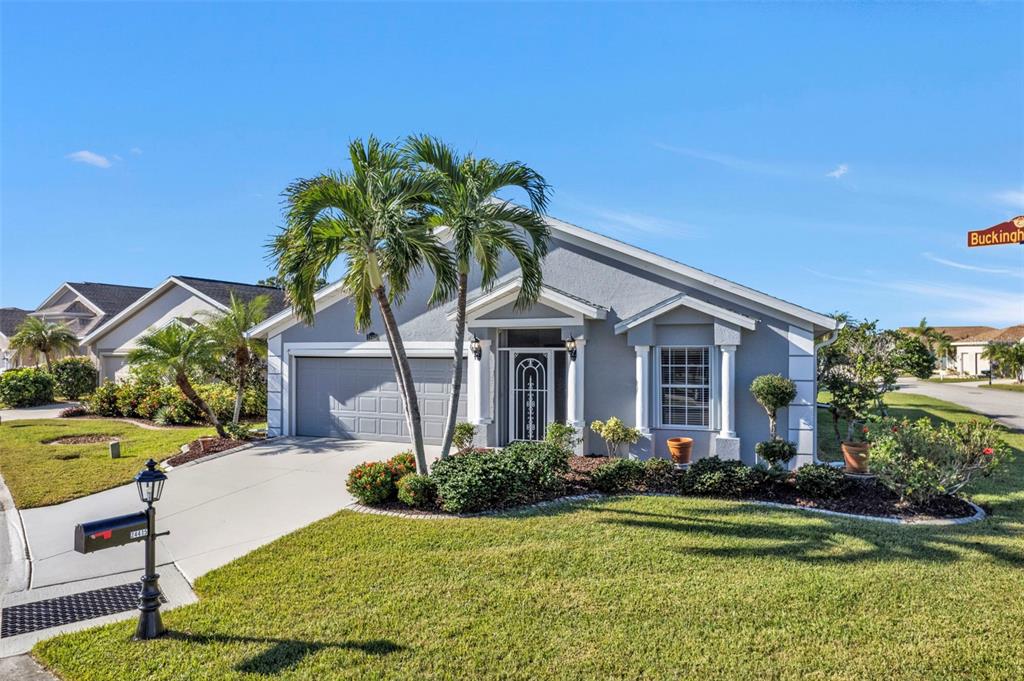 24415 Buckingham Way Punta Gorda, FL 33980 - Photo 2 of 41 a front view of a house with a garden