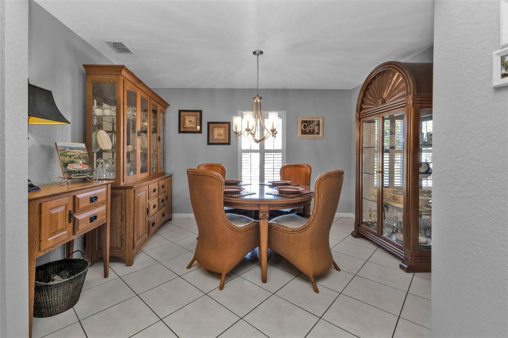 24415 Buckingham Way Punta Gorda, FL 33980 - Photo 6 of 41 a view of a dining room with furniture and chandelier