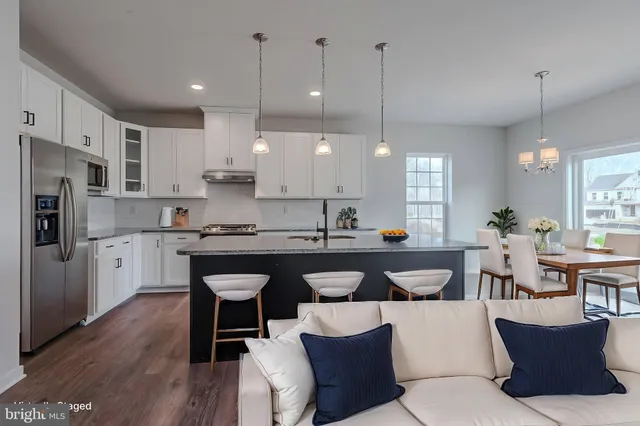 a large kitchen with a table and chairs
