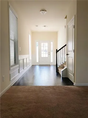 a view of entryway and hall with wooden floor
