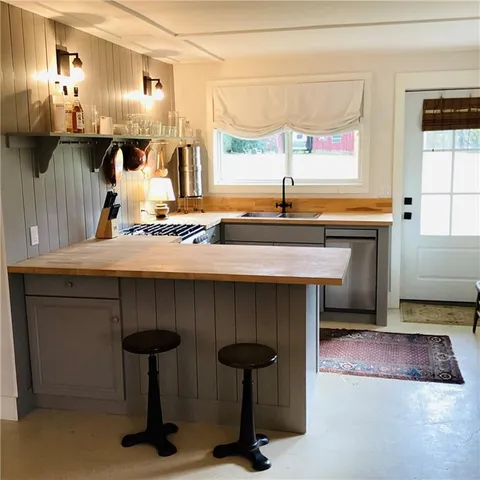 a kitchen with a sink cabinets and window