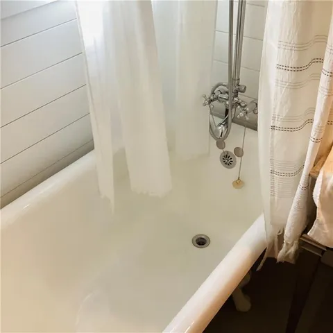 a bathroom with a tub and a shower