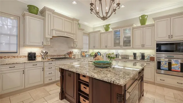 a kitchen with stainless steel appliances granite countertop a stove a sink dishwasher and cabinets with wooden floor