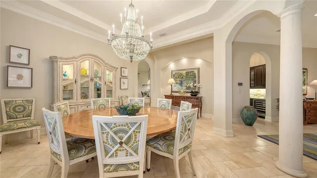 a view of a dining room with furniture and chandelier