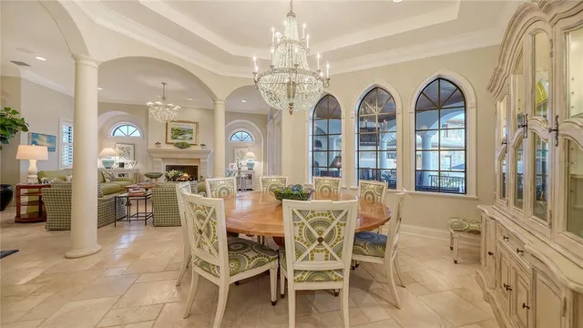 a kitchen with granite countertop a table chairs and a chandelier