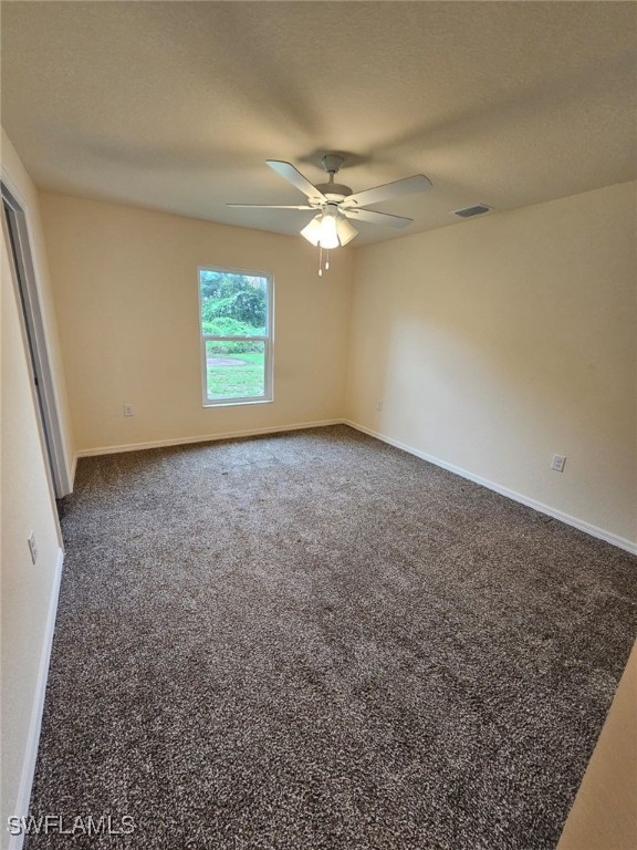 1506 Rugby Circle LaBelle, FL 33935 - Photo 3 of 13 an empty room with windows and fan