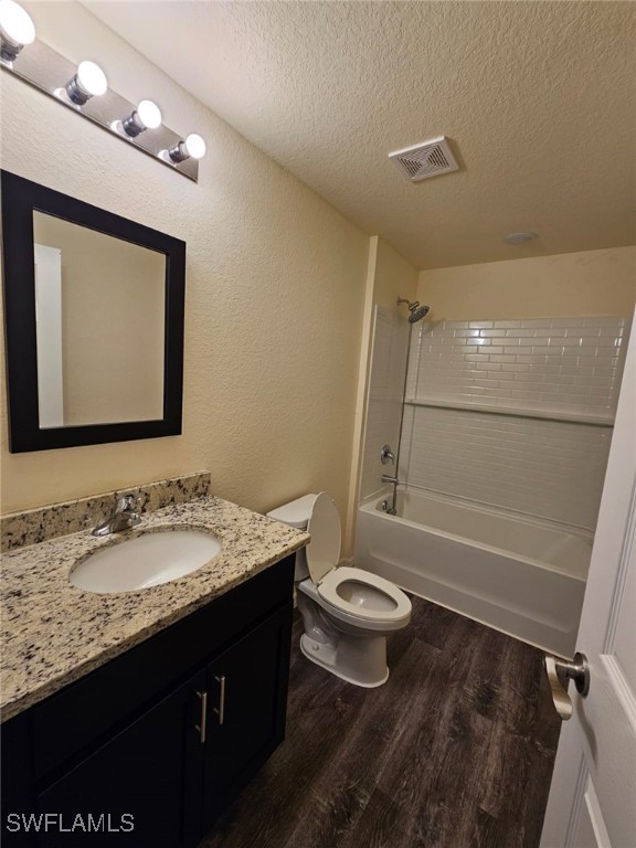 1506 Rugby Circle LaBelle, FL 33935 - Photo 9 of 13 a bathroom with a granite countertop sink a toilet a mirror and shower